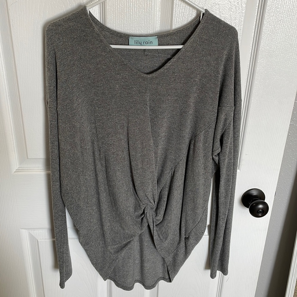 Long sleeve, gray sweater. Tied in front, long in back.
